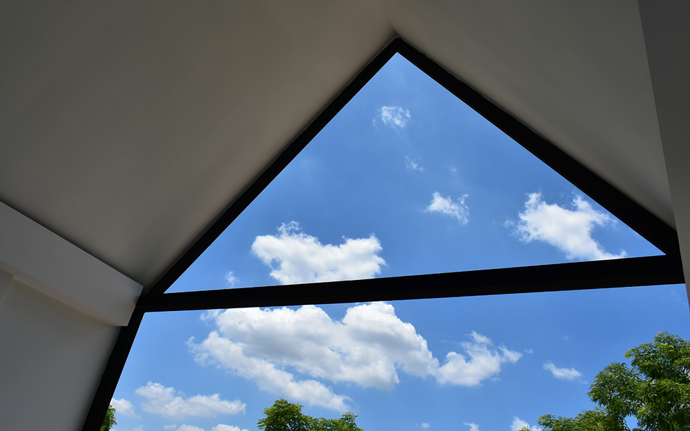 triangle window looking out at beautiful blue sky